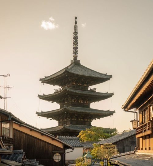 Scenic view of Yasaka Pagoda surrounded by traditional Kyoto architecture at sunset.