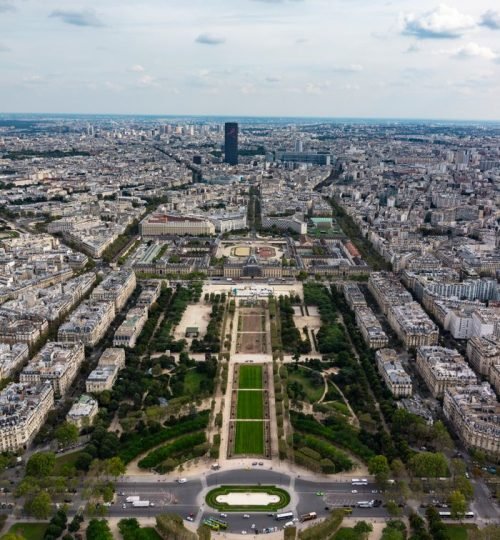 Stunning aerial shot of Champ de Mars with Paris skyline, showcasing vibrant city life.
